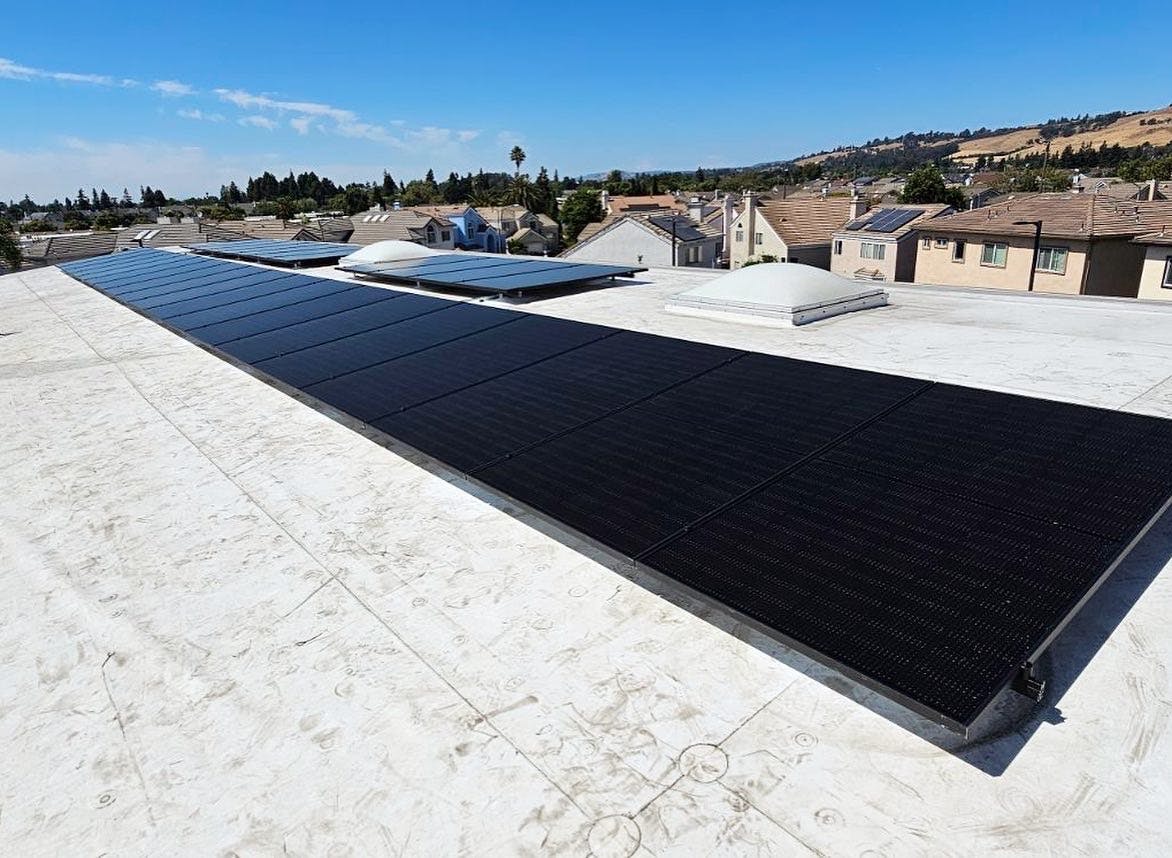 Solar Panels on White Residential Roof During Day